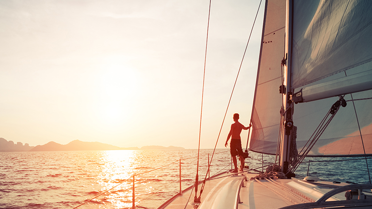 Person on a sailboat watching the sunset