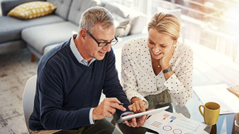Two people looking at a tablet