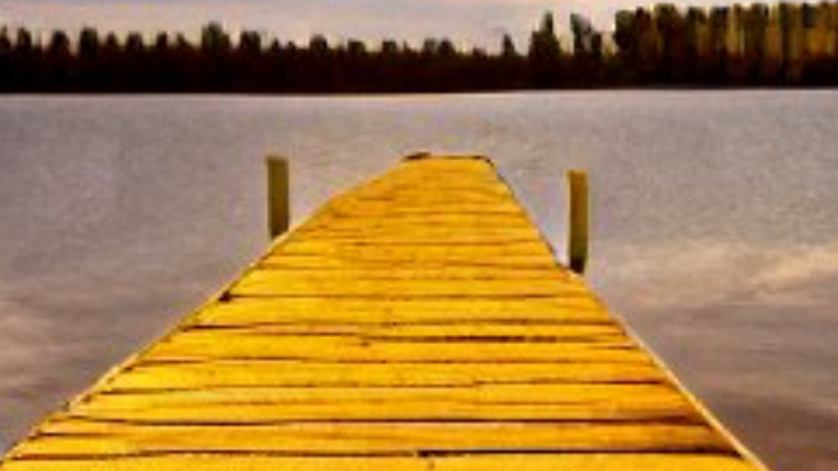 A picture of a dock in a lake.
