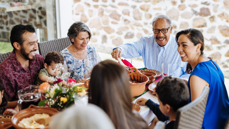 Happy multigenerational family eating dinner together