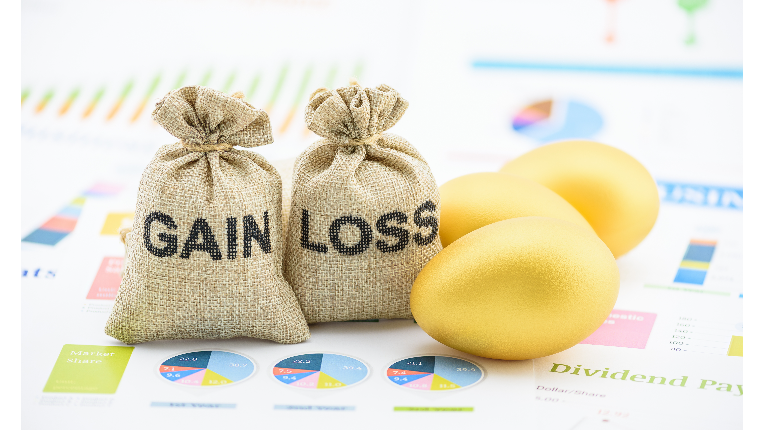 Two bags of money with gain and loss written on next to two gold eggs