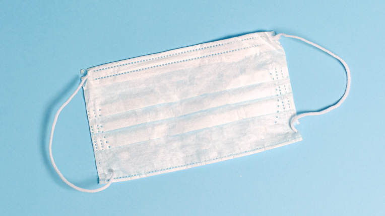 White Surgical Mask on Blue Background
