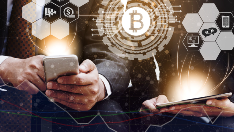 Cell phone and tablet with bitcoin symbol above