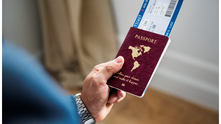 Man holding passport and plane ticket