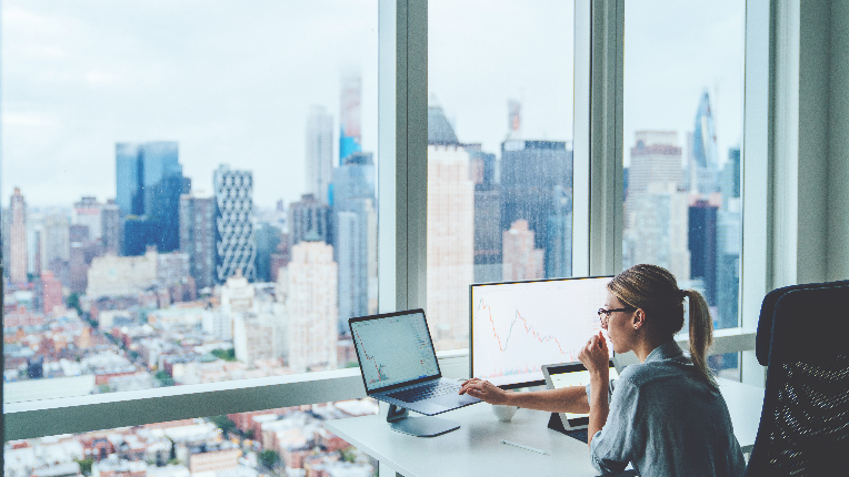 Woman in office looking at her computer.