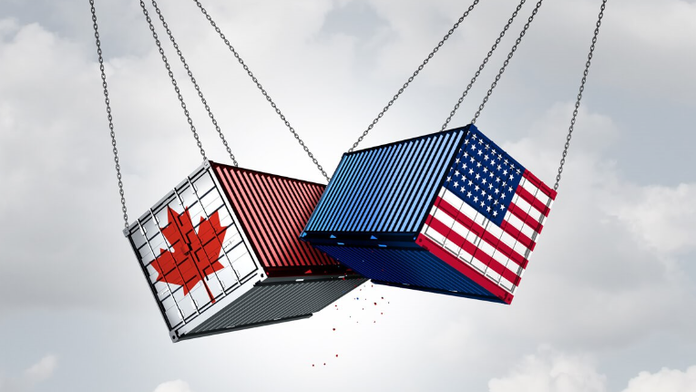 Two large shipping containers, one painted with the Canadian flag and the other with the US flag, are suspended by chains and appear to be colliding in mid-air.