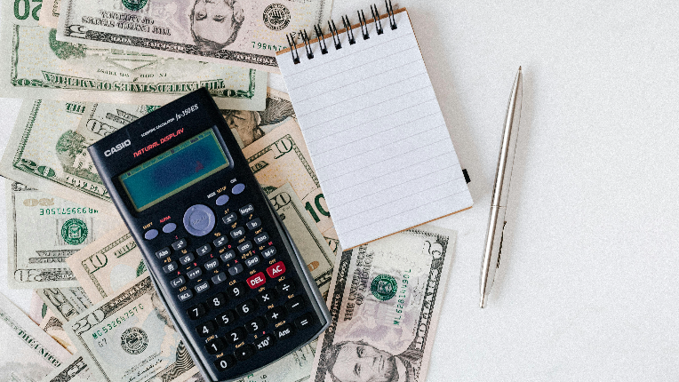 image of money, calculator, notepad