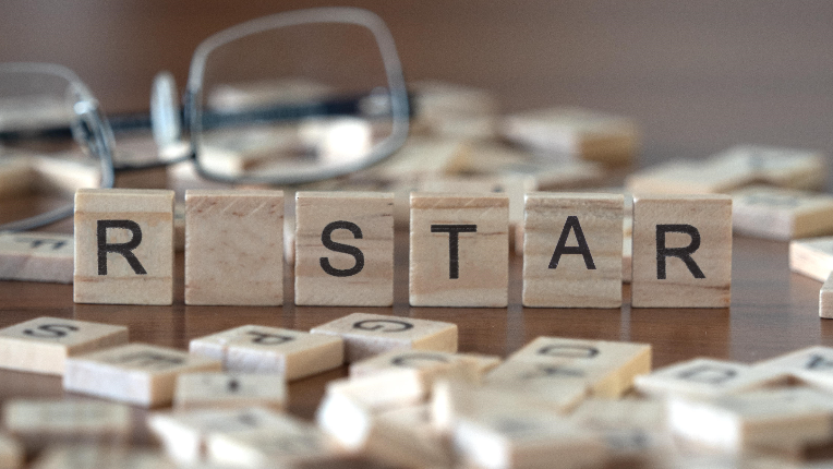 Scrabble pieces spelling R STAR.