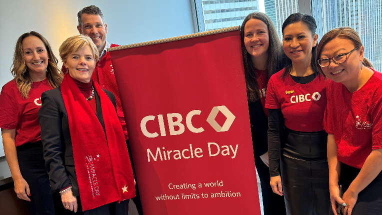 Team picture with Miracle Day sign