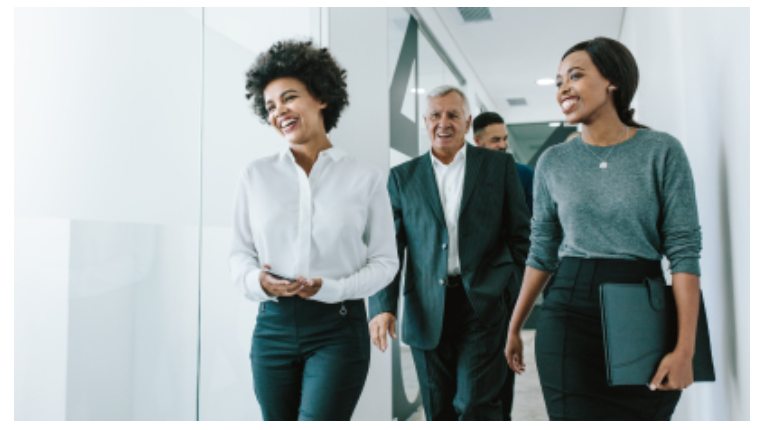 People walking in an office setting.
