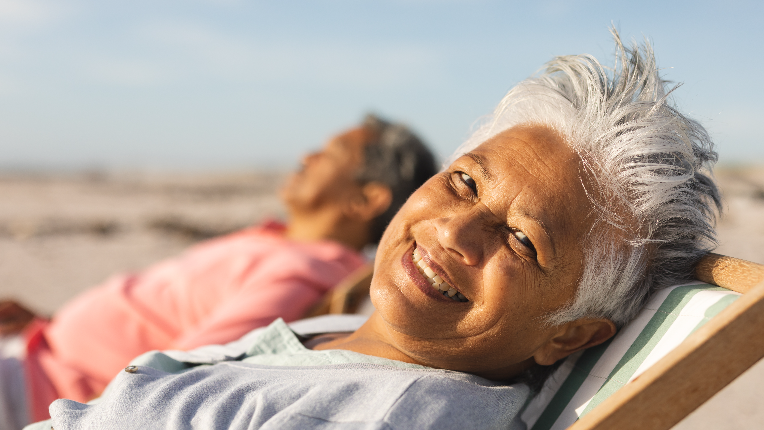 A woman who's retired leans back in her chair and doesn't have to worry about taxes