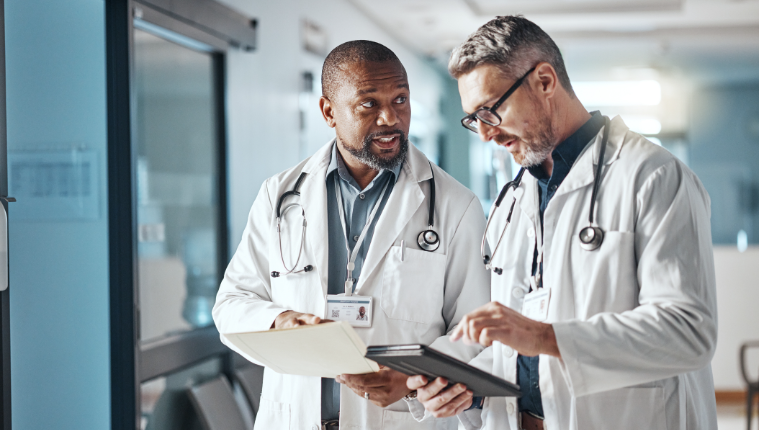 Two Physicians are discussing a file.