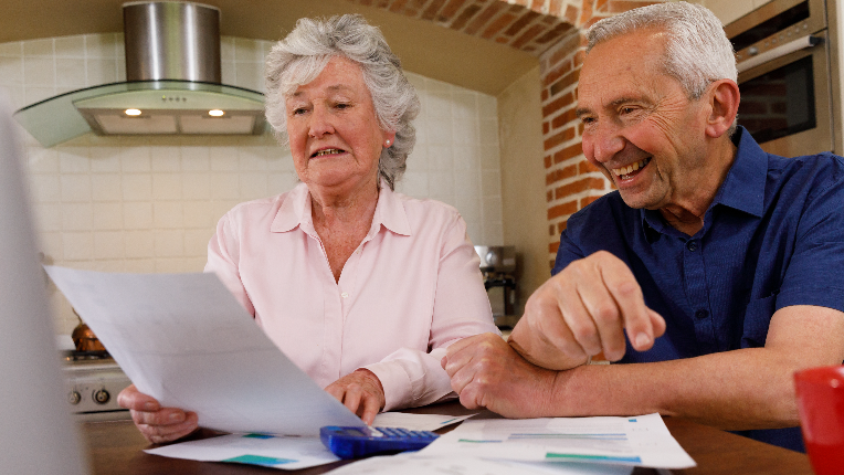 A couple does their finance plan while laughing