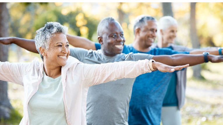 A group of seniors do a yoga pose