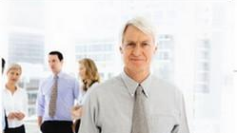 Man in tie with people in background