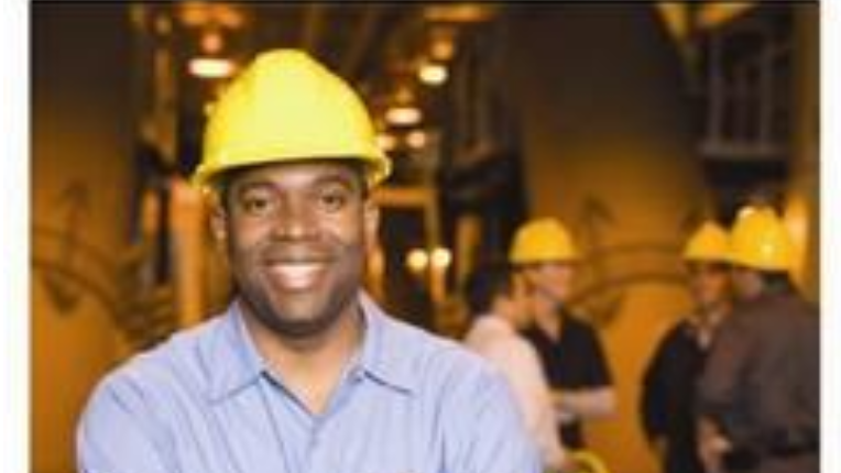 man in construction hat with crossed arms.