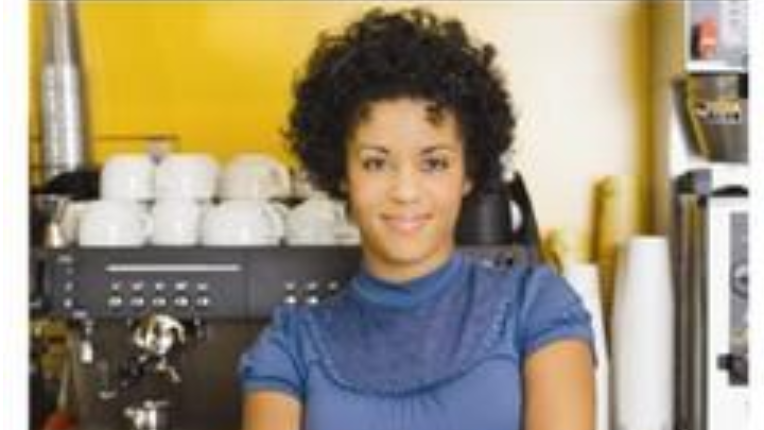 Woman behind the counter in a coffee shop.