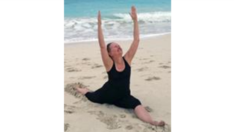 Kristine Pykala doing the splits on a beach