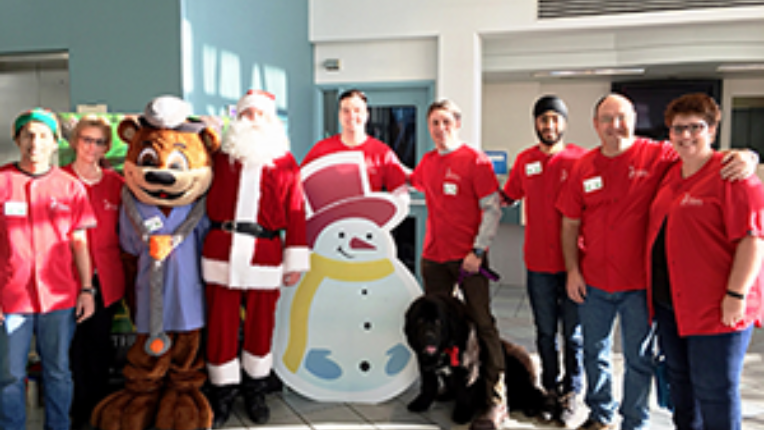 Kevin Punshon and his team in the IMAX theatre standing beside Santa