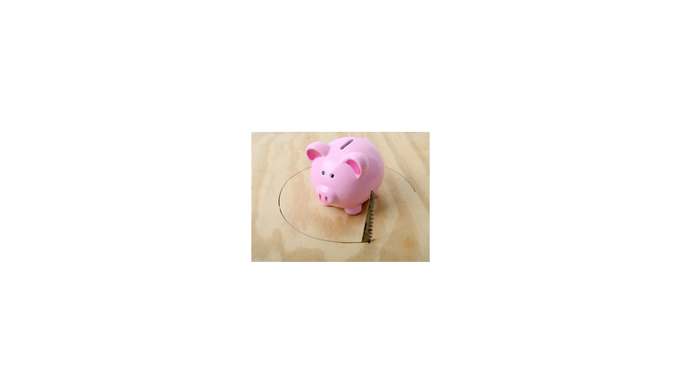 pink piggy bank with a circle being sawed beneath it.