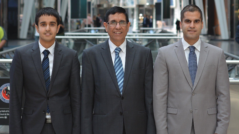 Avin, Ankit and Peter standing together as a team in the lobby at Toronto Brookfield Place.