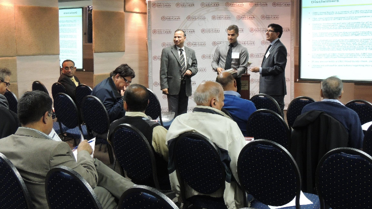 Avin, Peter and their co-worker stood in front of clients at Indo-Canada Chamber of Commerce event