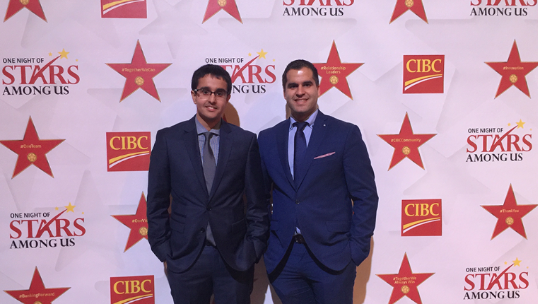 Ankit and Peter stood together smiling for a photo shot at an event