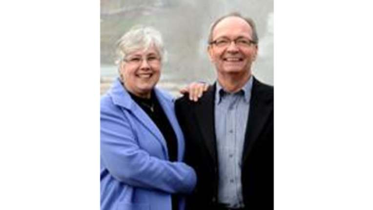 Glenna to the left and Bill on the right standing beside each other