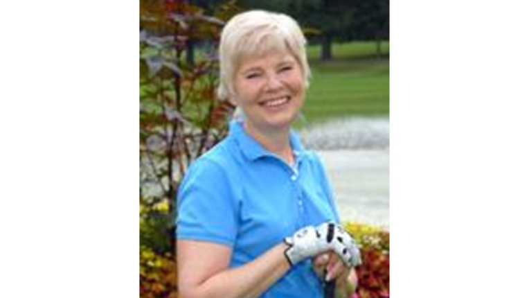 Janet standing and smiling