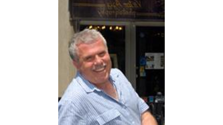 Victor leaning and smiling