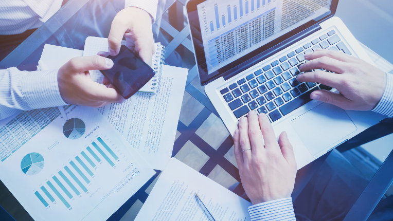 Two professionals reviewing performance documents