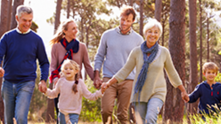 Multigenerational family walking in forest