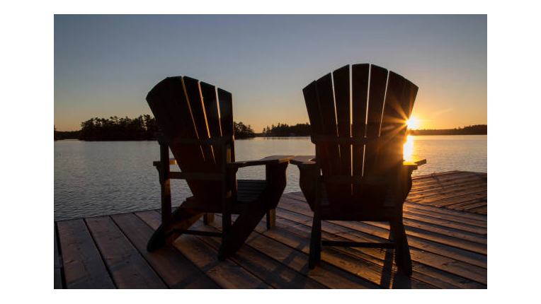 Muskoka chairs overlooking a lake