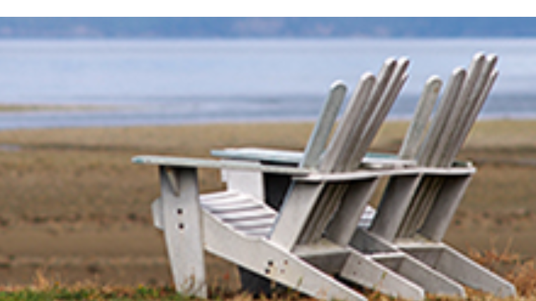 two chairs on a lake