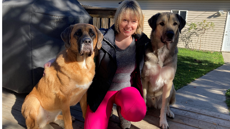 Tara posing with her two dogs