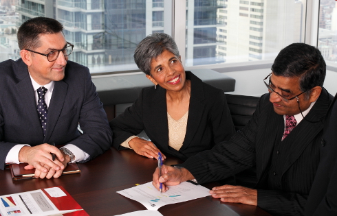 Mark Slater and two colleagues sitting at a conference table