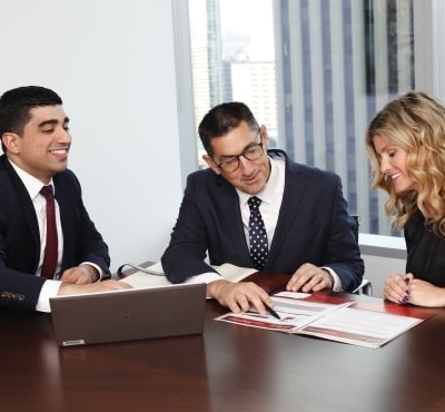 Mark Slater and his team at a conference table looking over some notes