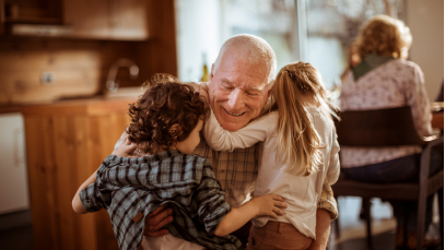 Grandfather hugging his grandchildren