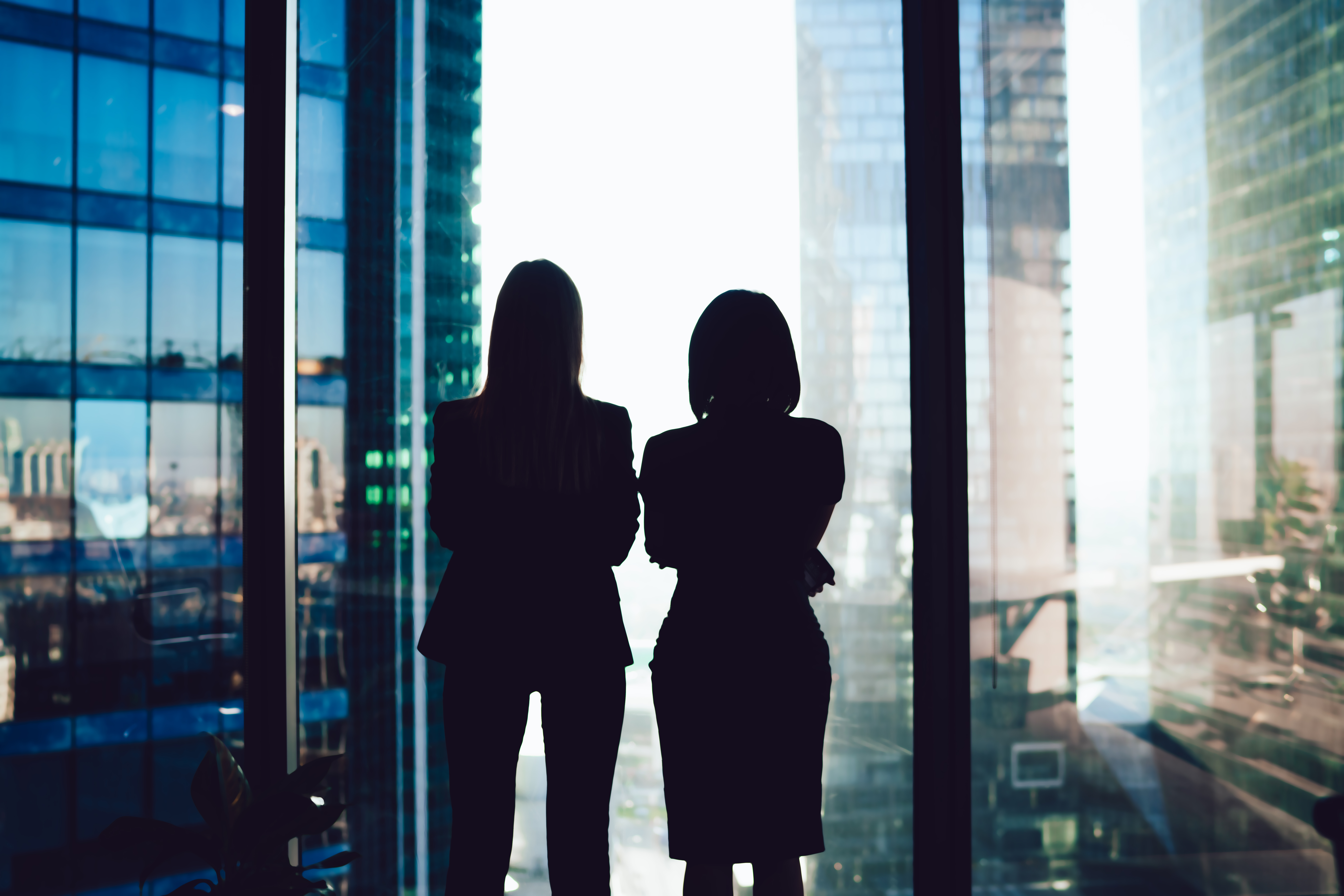 Two women looking out a window 