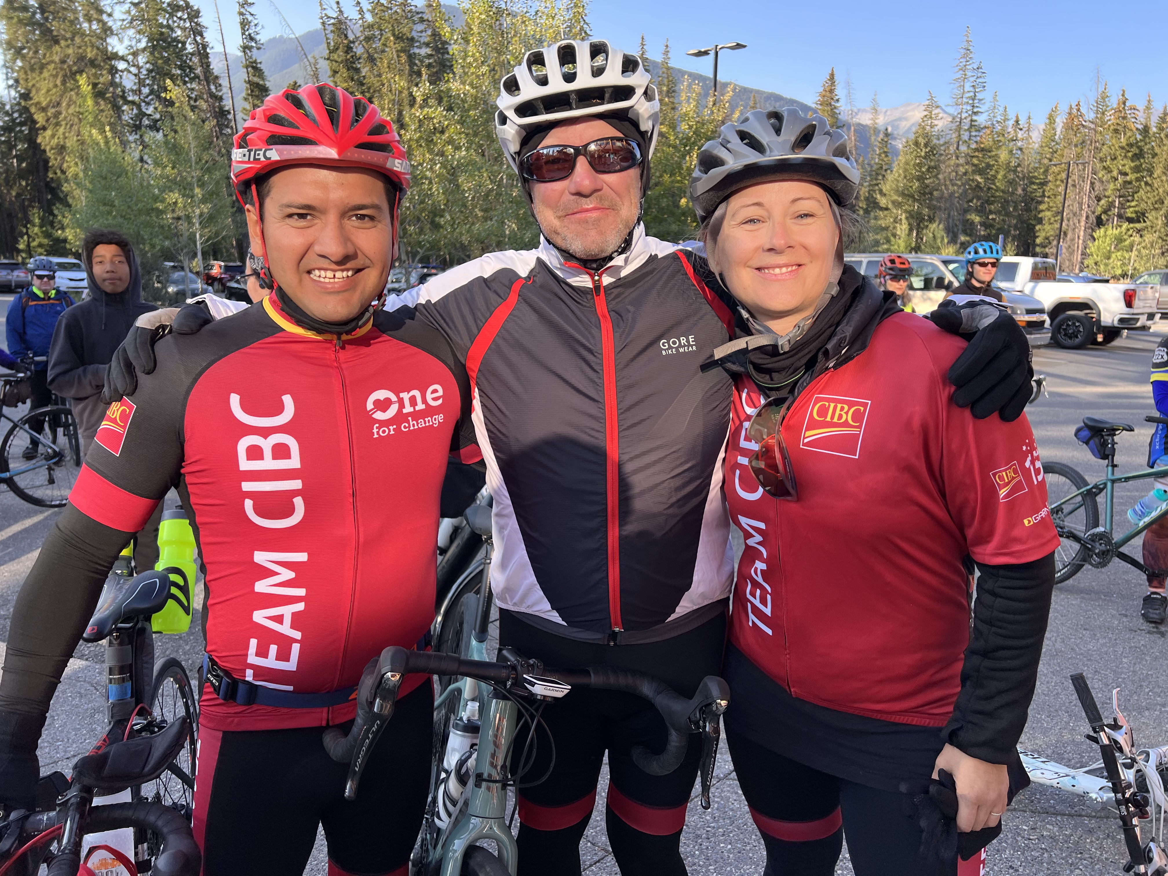 Three individuals in cycling gear. 