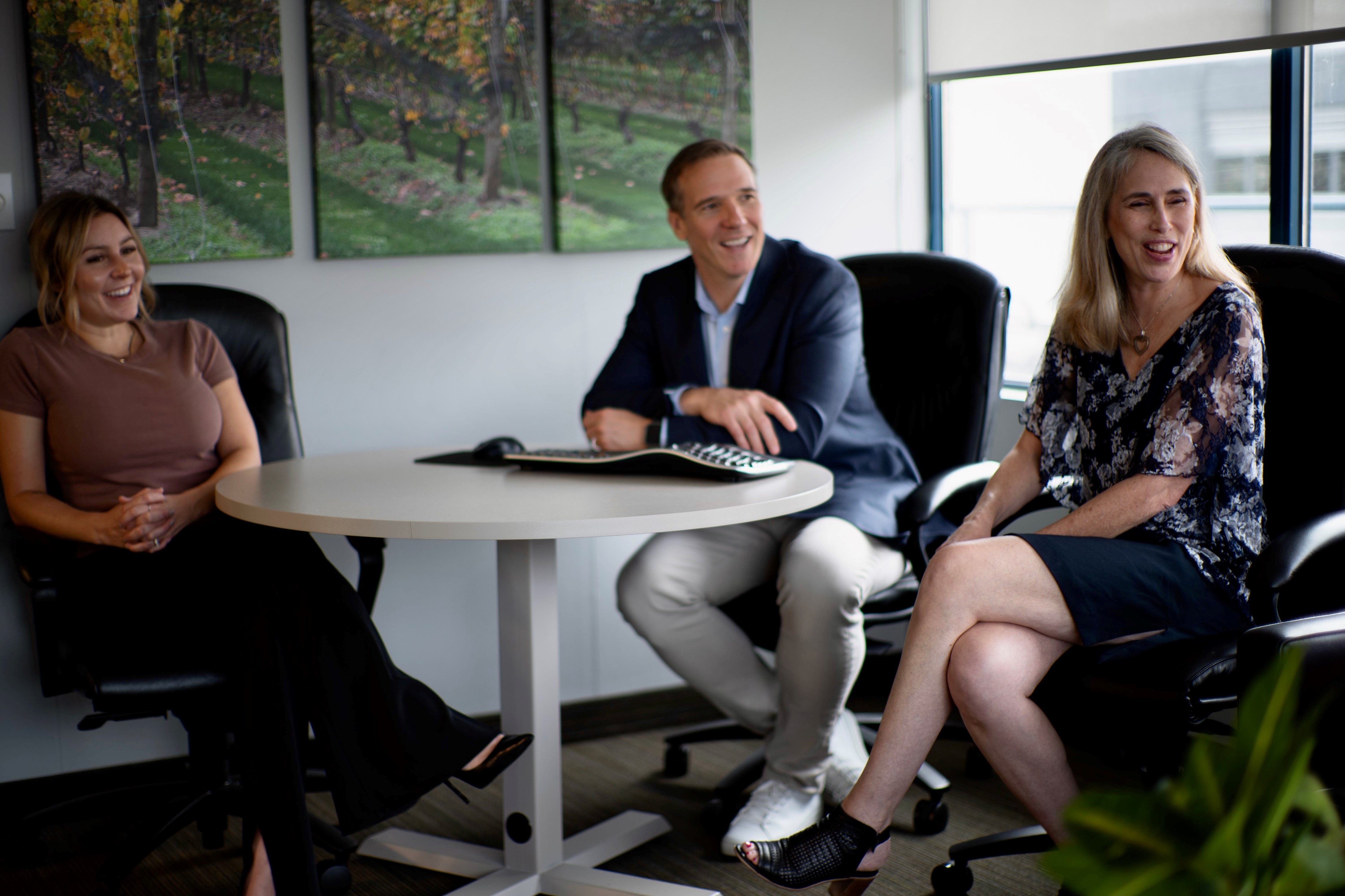 KWAG team at Brent's desk talking