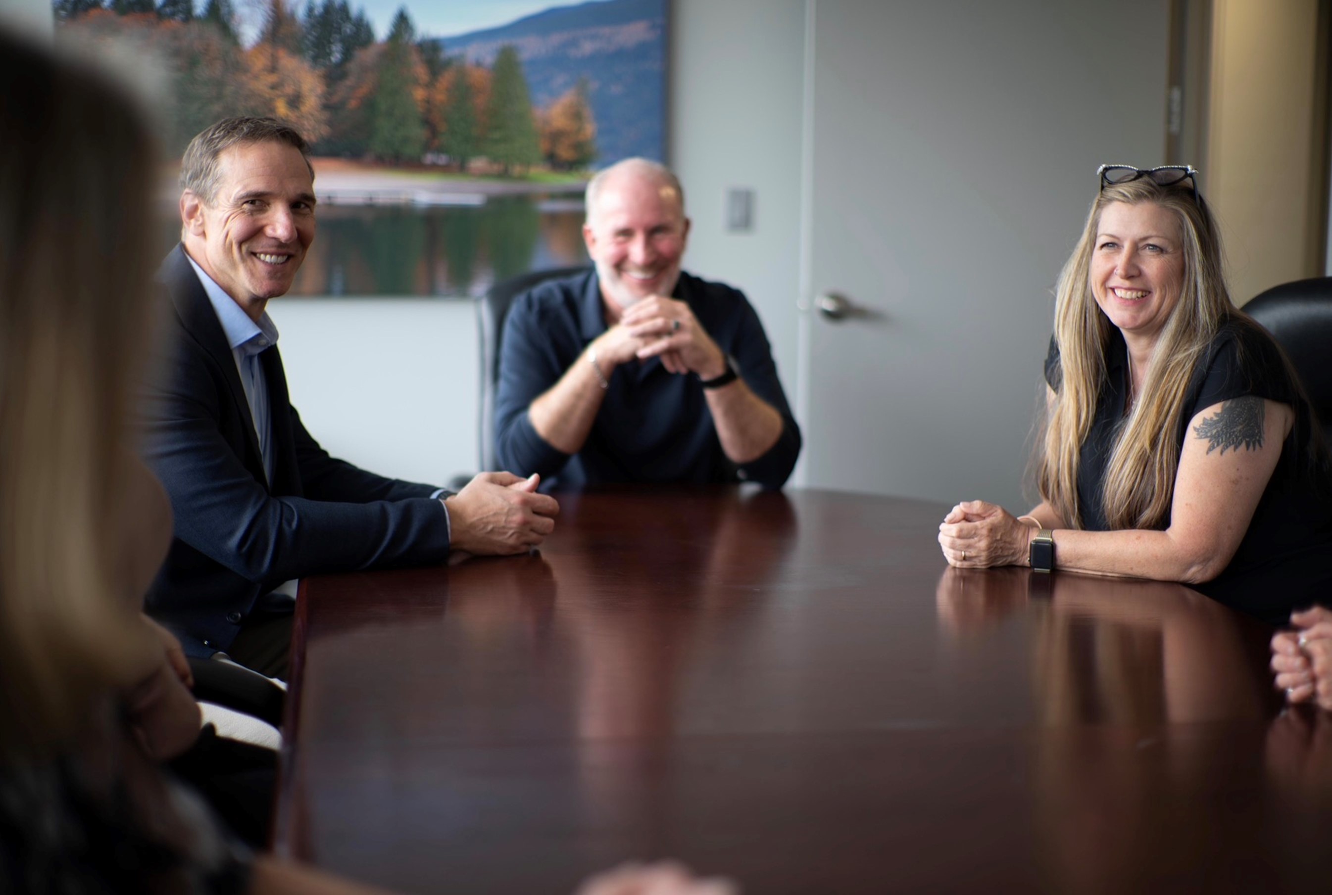 KWAG Team chatting at boardroom table