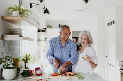 Retired couple cooking in kitchen 