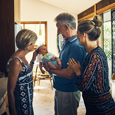 Multigenerational family holding a baby