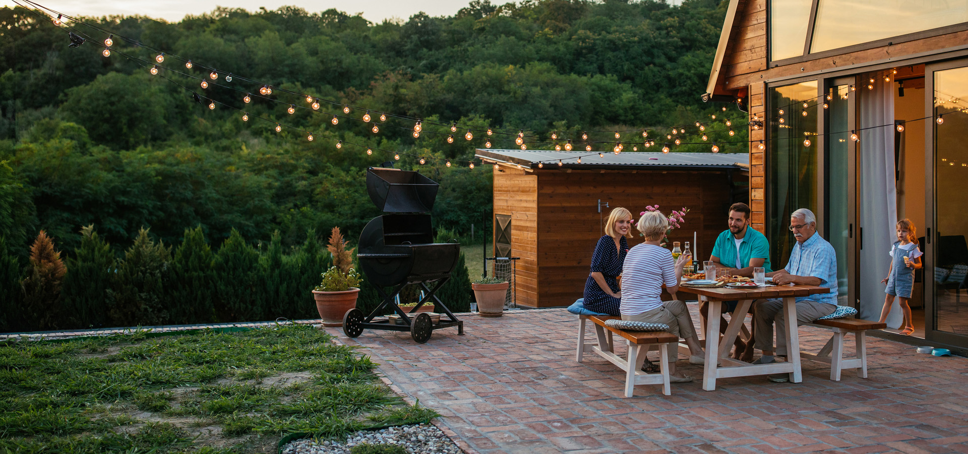 Consultation in a modern office next to a panel listing holistic wealth services