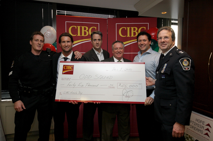 CIBC employee's giving a cheque to the Odd Squad program