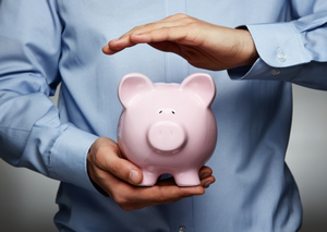 Closeup of hands holding a ‘piggy bank’