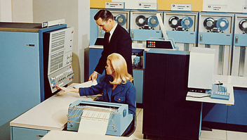 Woman and man working in a mainframe room circa 1960.