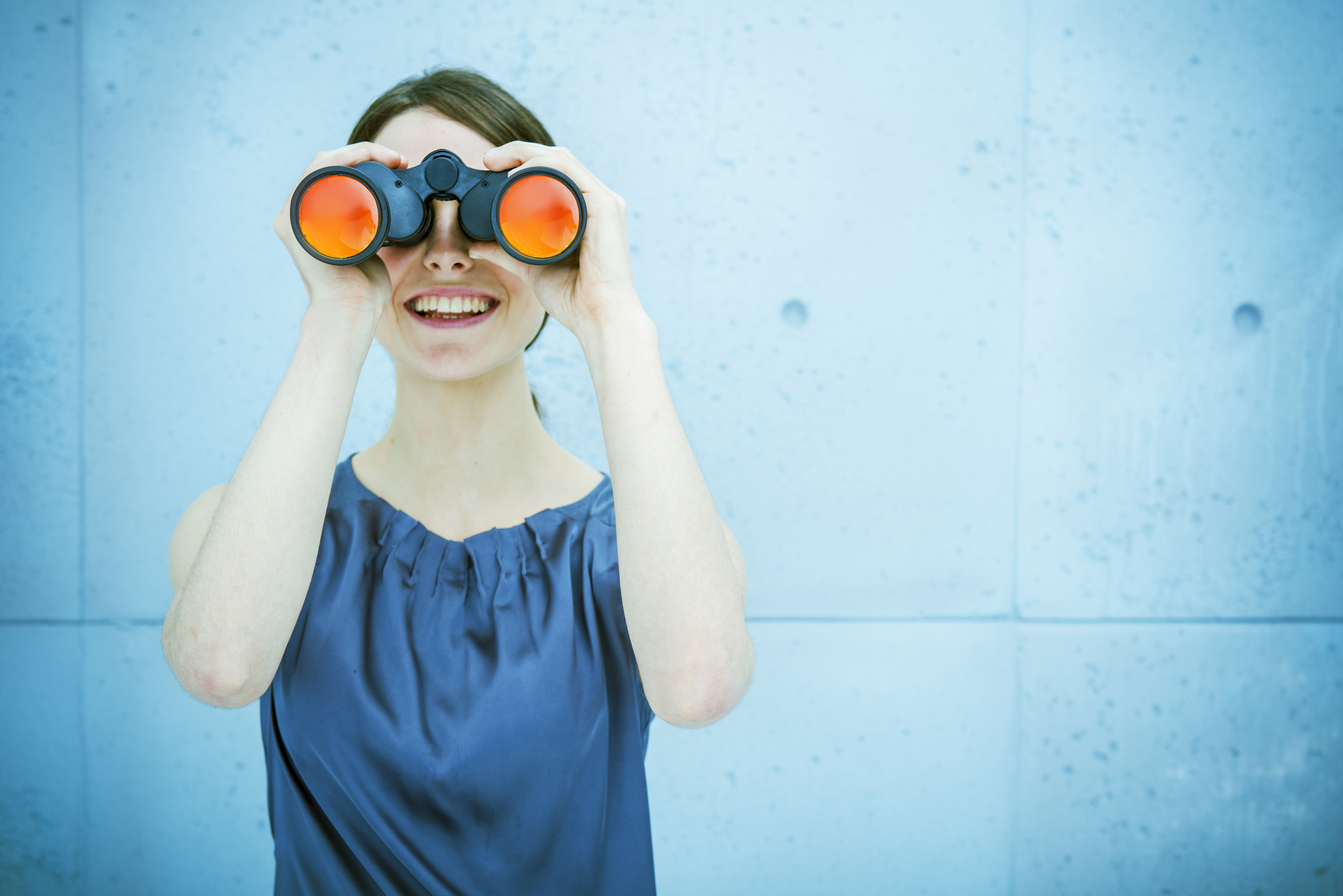 Woman looking through binoculars. 