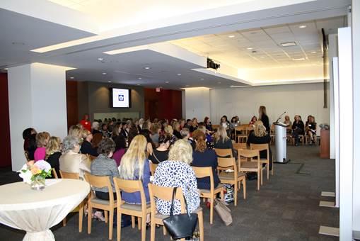 Room full of people participating in the Women in Wealth event